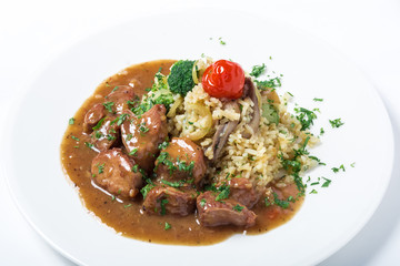 Turkey meat with rice, broccoli, mushrooms and gravy decorated greens.