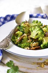 Broccoli with fried bacon and walnuts.
