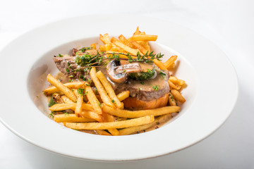 Roast pork on toast with mushrooms, sauce and french fries 