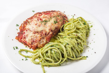Chicken with parmesan cheese and linguine pasta in pesto sauce