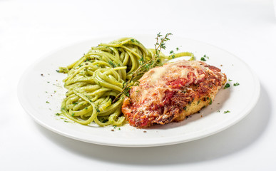 Chicken with parmesan cheese and linguine pasta in pesto sauce