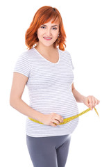 portrait of happy young pregnant woman with measure tape isolate