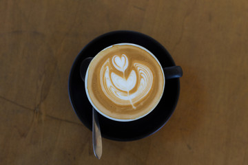 hot latte art coffee in black mug