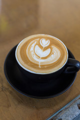 hot latte art coffee in black mug