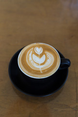 hot latte art coffee in black mug