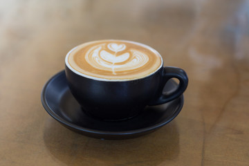 hot latte art coffee in black mug