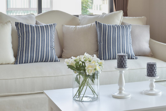 Blue Striped Pillows On A Casual Sofa And Decorative Flower In Living Room