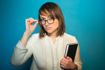 Strict teacher woman in glasses with a book