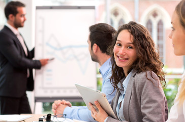 Young attractive businesswoman working at the office with associ