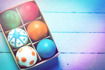 Easter concept with colorful eggs on wooden background