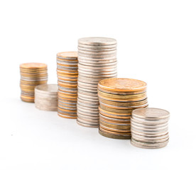 Columns of old coins on a white background