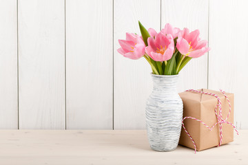 Fresh pink tulips and gift box