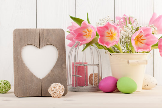 Pink tulips, Easter eggs and heart shaped blank frame