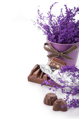 Still life with chocolate bar in foil, chocolates