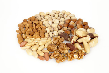 Mixed nuts - almonds, pistachios, hazelnuts, brazil nuts, walnuts, peanuts on the white background, circle, rounded on top