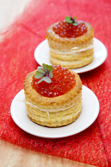 Tartlets with red caviar on plate.