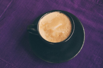 Coffee cup on breakfast table, vintage warm color tone.