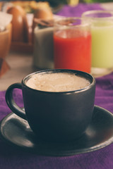 Coffee cup on breakfast table, vintage warm color tone.