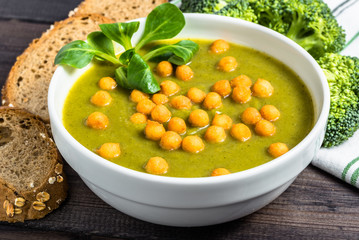 Italian broccoli soup or cream soup on wooden table.