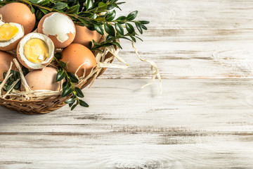 Fototapeta na wymiar Easter eggs in easter basket on wooden background.