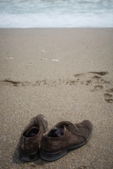 Fototapeta na wymiar Shoes on a beach