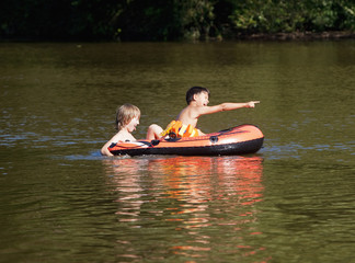 Fototapeta na wymiar Two Boys Having Fun on Inflatable Rubber Boat