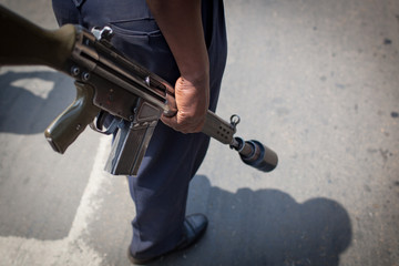 Riot policeman with tear gas rifle