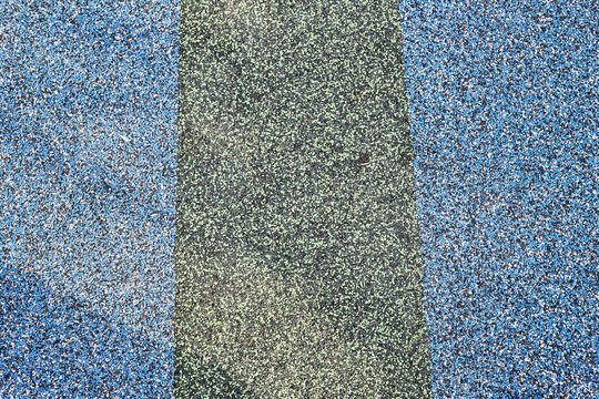 Texture. Childrens playground floor.Rubber and stones.