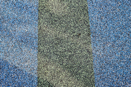 Texture. Childrens playground floor.Rubber and stones.
