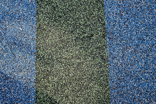 Texture. Childrens playground floor.Rubber and stones.