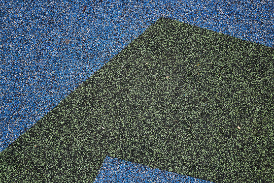 Texture. Childrens playground floor.Rubber and stones.