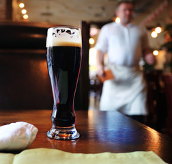 glass of dark beer in a restaurant interior