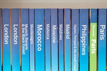 Guidebooks on a shelf - 103993295