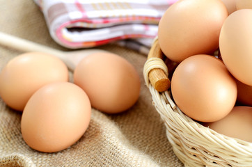 Wicker basket with eggs on a linen tablecloth