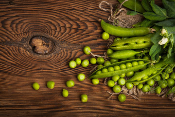 Fresh organic green peas on a wooden background.Rustic style.
