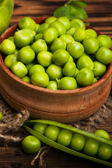 Fresh organic green peas on a wooden background.Rustic style.