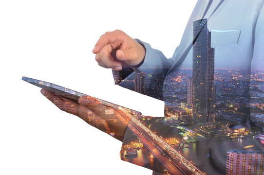 Double Exposure image of Businessman use Digital Tablet and City
