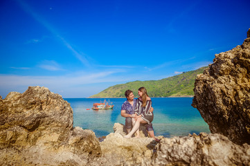 Fototapeta na wymiar Joyful honeymoon couple playing on a beach in Phuket, Thailand