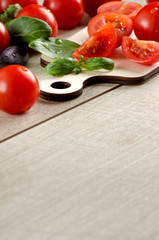 Cherry tomatoes, purple and green Basil on wooden table