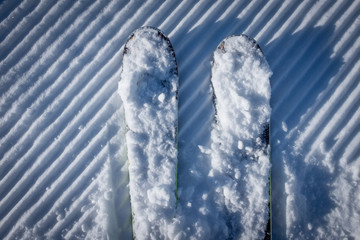 Skis on groomed piste