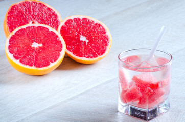 A glass of refreshing drink with grapefruit and grapefruit