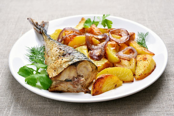 Fried mackerel fish with potato wedges