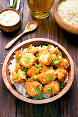 Chicken meat with orange sauce and green onion