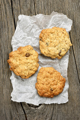 Oats cookies on baking paper, top view