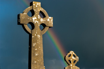 Rainbow over Irish celtic cemetery