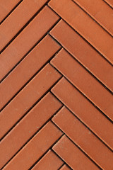 Red narrow bricks herringbone background vertical composition