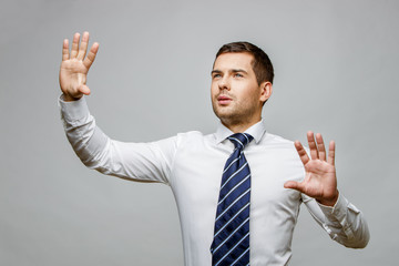 Handsome stylish businessman on grey background