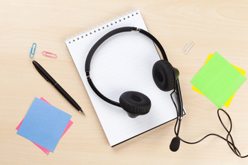 Office desk with headset and supplies