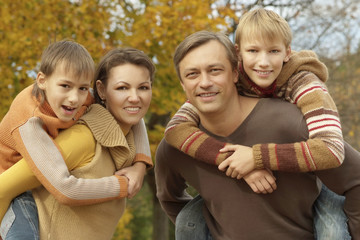 Fototapeta na wymiar Happy family in autumn forest