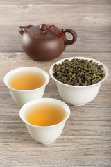 Obraz na płótnie Canvas Cups of green tea and leaves